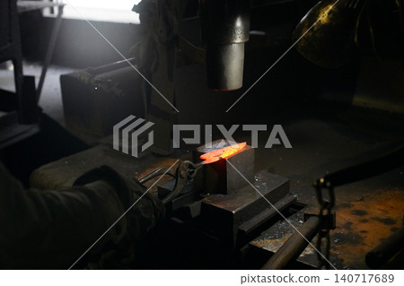 A craftsman who hammers heated materials into shapes 140717689