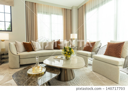 Light brown and white pillows on sofa in the living room with area rug. Light brown and white pillows on sofa in the living room with area rug. 140717703