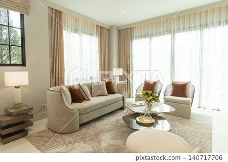 Light brown and white pillows on sofa in the living room with area rug. Light brown and white pillows on sofa in the living room with area rug. 140717706