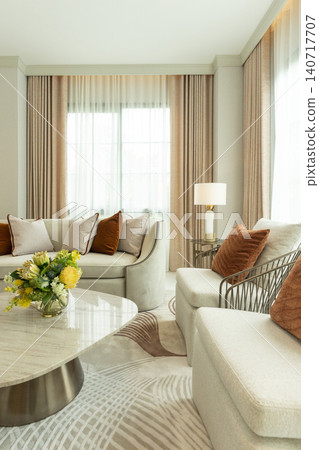Light brown and white pillows on sofa in the living room with area rug. Light brown and white pillows on sofa in the living room with area rug. 140717707