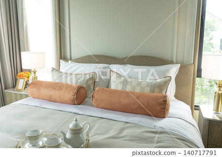 King Size Canopy Bed Frame with pillows in elegant bedroom interior. Honeymoon suite bedroom in pastel and pink colors style bedroom in white room Boudoir. King Size Canopy Bed Frame with pillows in elegant bedroom interior. Honeymoon suite bedroom in pastel and pink colors style bedroom in white room Boudoir. 140717791