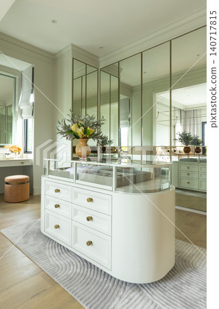 Luxury modern walk-in closet with mirror cabinets facades and island console. Luxury modern walk-in closet with mirror cabinets facades and island console. 140717815
