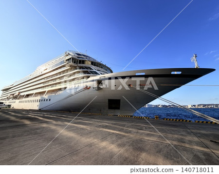 A scene of a large cruise ship docked in the harbor. A scene of a large cruise ship docked in the harbor. 140718011