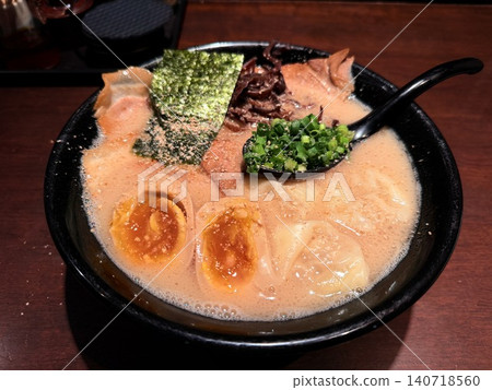 Rich pork bone broth ramen served in a black bowl. Rich pork bone broth ramen served in a black bowl. 140718560
