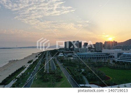 Sunset view from the air over the beach and coastal road near Xiamen Convention Center Sunset view from the air over the beach and coastal road near Xiamen Convention Center 140719013