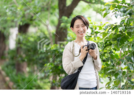 A woman with a camera A woman with a camera 140719316