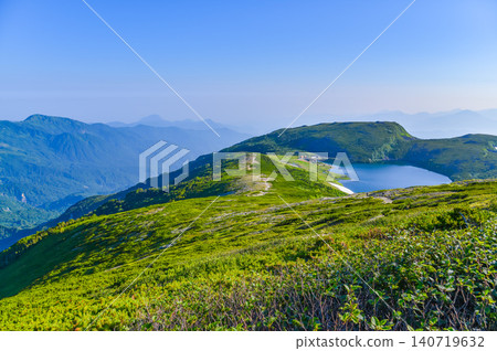 在晴朗的夏日,從北阿爾卑斯山脈白馬山脈的健行步道上,可以遠眺白馬禦池湖和白馬乘鞍山的全景。 在晴朗的夏日,從北阿爾卑斯山脈白馬山脈的健行步道上,可以遠眺白馬禦池湖和白馬乘鞍山的全景。 140719632