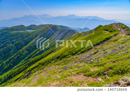 On a clear summer day, Hakuba Oike Lake and the distant, hazy Myoko landscape can be seen from the Northern Alps and the Hakuba mountain range. On a clear summer day, Hakuba Oike Lake and the distant, hazy Myoko landscape can be seen from the Northern Alps and the Hakuba mountain range. 140719849