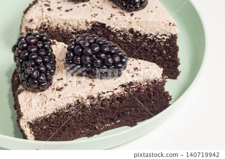 A slice of chocolate cake with forest berries A slice of chocolate cake with forest berries 140719942