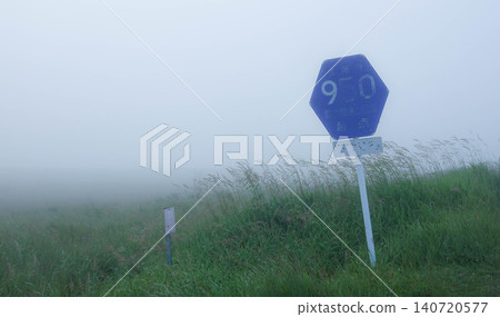 A sign on Hokkaido Prefectural Road 950 running through the Notsuke Peninsula in Betsukai Town, Hokkaido, amidst sea fog in summer. A sign on Hokkaido Prefectural Road 950 running through the Notsuke Peninsula in Betsukai Town, Hokkaido, amidst sea fog in summer. 140720577