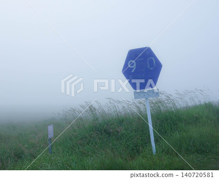 A sign on Hokkaido Prefectural Road 950 running through the Notsuke Peninsula in Betsukai Town, Hokkaido, amidst sea fog in summer. 140720581