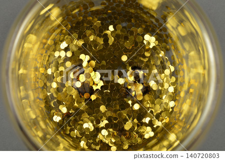 Golden Confetti Inside a Glass Container Golden Confetti Inside a Glass Container 140720803