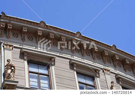 Historical building facade with ornate architectural details and statues 140720814