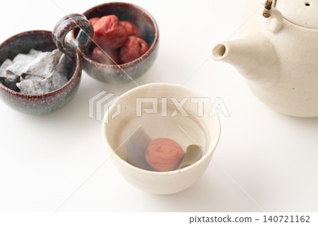 Plum and kelp tea poured into a teacup Plum and kelp tea poured into a teacup 140721162