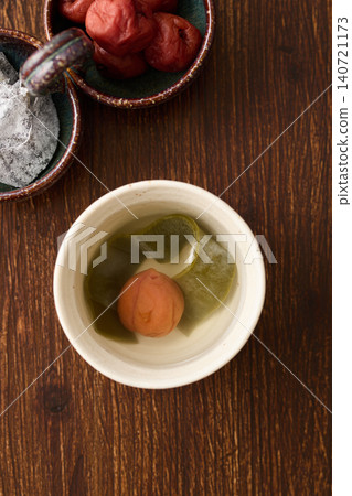 Plum and kelp tea poured into a teacup Plum and kelp tea poured into a teacup 140721173