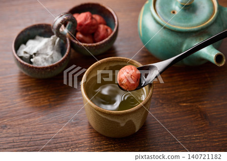 Plum and kelp tea poured into a teacup Plum and kelp tea poured into a teacup 140721182