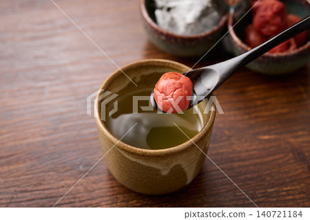 Plum and kelp tea poured into a teacup Plum and kelp tea poured into a teacup 140721184