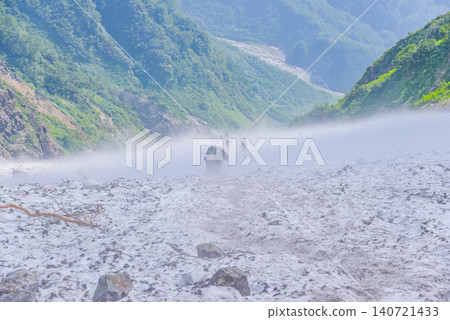 Summer morning light: A scene of hikers making their way along the mountain trail, enveloped in the rising mist of the Hakuba Daisekkei (Hakuba Great Snow Valley). Summer morning light: A scene of hikers making their way along the mountain trail, enveloped in the rising mist of the Hakuba Daisekkei (Hakuba Great Snow Valley). 140721433