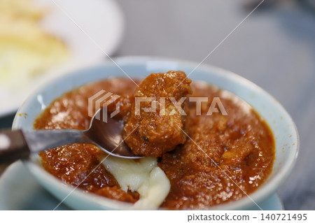 Spicy Curry Dish with Spoon in Light Blue Bowl Spicy Curry Dish with Spoon in Light Blue Bowl 140721495