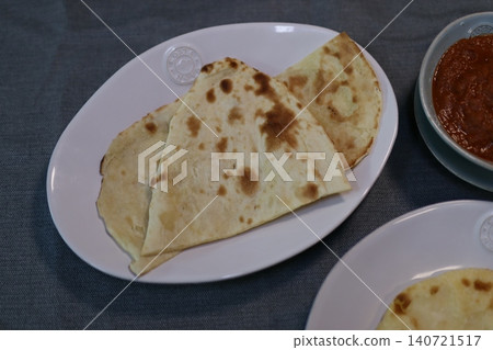 Flatbreads and Sauce on Plates Flatbreads and Sauce on Plates 140721517