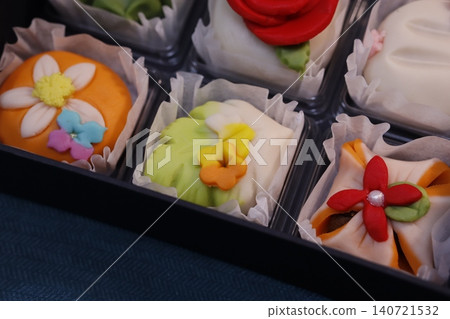 Colorful Flower-Decorated Pastries in Tray 140721532