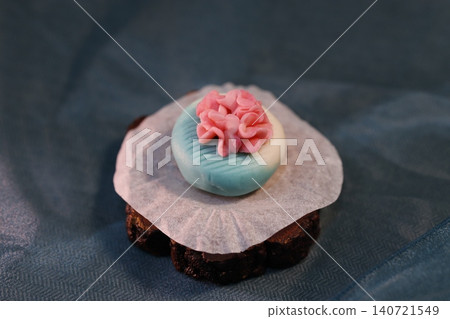 Delicate Pastel Cupcake with Pink Sugar Flower Delicate Pastel Cupcake with Pink Sugar Flower 140721549