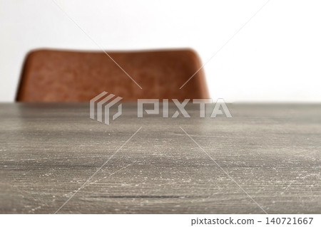 Modern Minimalist Interior with Leather Accent Chair and Old Textured Wooden Table Surface, Contemporary Furniture Design for Home Office or Living Space. Modern Minimalist Interior with Leather Accent Chair and Old Textured Wooden Table Surface, Contemporary Furniture Design for Home Office or Living Space. 140721667