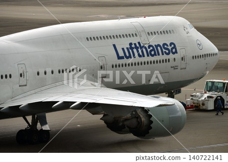 A Lufthansa Boeing 747-8 being pushed back at the airport tarmac. A Lufthansa Boeing 747-8 being pushed back at the airport tarmac. 140722141