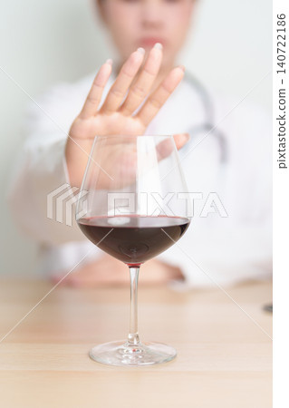 Doctor hand stop to refuse Wine, quitting drink for healthy liver, prevent Alcoholic cirrhosis and cancer, World No Alcohol Day, medical advice for sobriety and Alcoholism and addiction concept 140722186