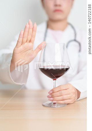 Doctor hand stop to refuse Wine, quitting drink for healthy liver, prevent Alcoholic cirrhosis and cancer, World No Alcohol Day, medical advice for sobriety and Alcoholism and addiction concept Doctor hand stop to refuse Wine, quitting drink for healthy liver, prevent Alcoholic cirrhosis and cancer, World No Alcohol Day, medical advice for sobriety and Alcoholism and addiction concept 140722188