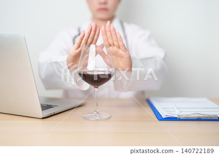 Doctor hand stop to refuse Wine, quitting drink for healthy liver, prevent Alcoholic cirrhosis and cancer, World No Alcohol Day, medical advice for sobriety and Alcoholism and addiction concept Doctor hand stop to refuse Wine, quitting drink for healthy liver, prevent Alcoholic cirrhosis and cancer, World No Alcohol Day, medical advice for sobriety and Alcoholism and addiction concept 140722189