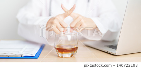 Doctor hand stop to refuse Whisky, quitting drink for healthy liver, prevent Alcoholic cirrhosis and cancer, World No Alcohol Day, medical advice for sobriety and Alcoholism and addiction concept 140722198