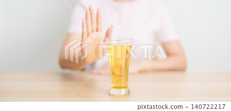 woman making stop hand gesture to refuse a glass of Beer, Healthy man say no to alcohol drink, stop alcoholism and addiction concept. Responsible man reject a drink before driving and quit booze woman making stop hand gesture to refuse a glass of Beer, Healthy man say no to alcohol drink, stop alcoholism and addiction concept. Responsible man reject a drink before driving and quit booze 140722217