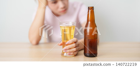 Stressed woman drinking beer alone with problem. Exhausted drunk woman looking stressed and sleepy. Alcohol addiction, Alcoholism, emotional distress and mental health concept Stressed woman drinking beer alone with problem. Exhausted drunk woman looking stressed and sleepy. Alcohol addiction, Alcoholism, emotional distress and mental health concept 140722219