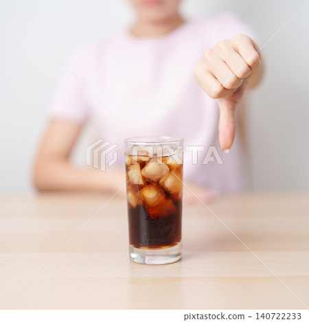 Healthy woman hand thumbs down to soft drink and soda, say no to sugar and carbonated beverage, healthy lifestyle, Acid reflux, Heartburn and Gastritis concept Healthy woman hand thumbs down to soft drink and soda, say no to sugar and carbonated beverage, healthy lifestyle, Acid reflux, Heartburn and Gastritis concept 140722233
