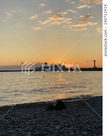 Passenger ship at sunset near harbor on calm sea Passenger ship at sunset near harbor on calm sea 140722414