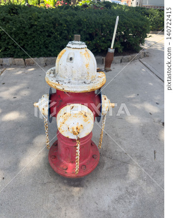Close-up of a red and white fire hydrant; fire safety equipment installed outdoors. Close-up of a red and white fire hydrant; fire safety equipment installed outdoors. 140722415
