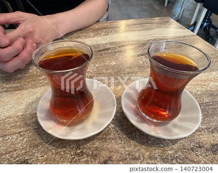 Enjoy traditional Turkish tea (chai) in a tulip-shaped glass. Enjoy traditional Turkish tea (chai) in a tulip-shaped glass. 140723004