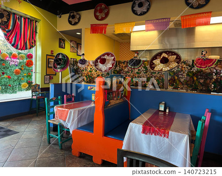 The interior of an American Mexican restaurant is decorated with colorful ornaments. The interior of an American Mexican restaurant is decorated with colorful ornaments. 140723215