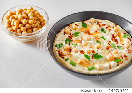hummus in bowl with olive oil and chickpeas, selective focus 140723735