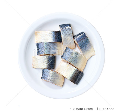 Herring pieces on a white ceramic plate isolated on a white background, top view. 140723828