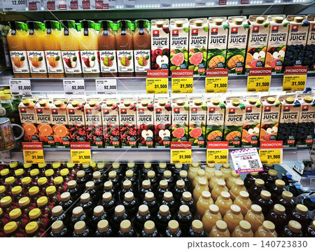 SURABAYA, INDONESIA - June 12, 2026. Various colorful bottled fruit juices and beverages arranged on shelves in a supermarket refrigerator display. 140723830