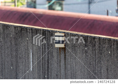 Railway sign (speed limit lifted sign) installed on a concrete sound barrier. Railway sign (speed limit lifted sign) installed on a concrete sound barrier. 140724128