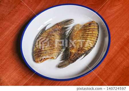 Snakeskin gourami crispy fried fishes in Thai local style white plate Snakeskin gourami crispy fried fishes in Thai local style white plate 140724597