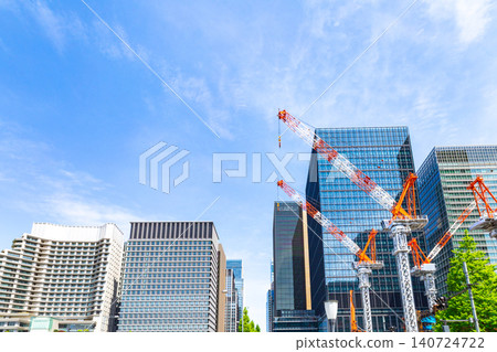 Large cranes and skyscrapers at a construction site Large cranes and skyscrapers at a construction site 140724722