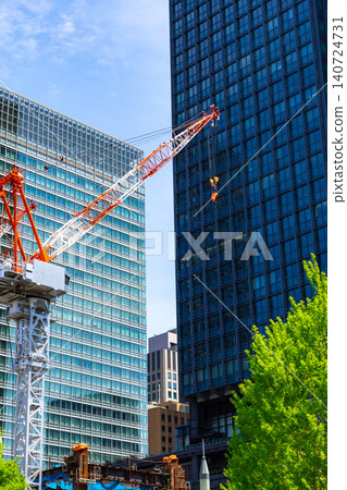 Large cranes and skyscrapers at a construction site Large cranes and skyscrapers at a construction site 140724731