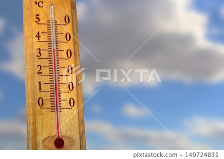 Thermometer showing temperature in degrees Celsius against a bright blue sky with clouds Thermometer showing temperature in degrees Celsius against a bright blue sky with clouds 140724831