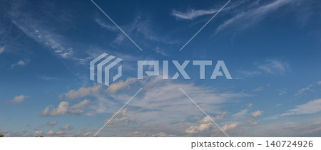 Vibrant blue sky with fluffy white clouds during late afternoon at a rural location Vibrant blue sky with fluffy white clouds during late afternoon at a rural location 140724926