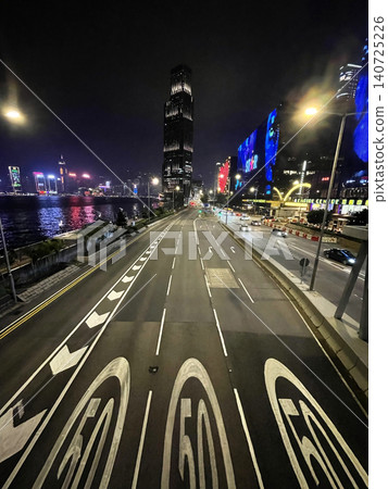 Hong Kong cityscape at night with illuminated skyscrapers and busy road traffic Hong Kong cityscape at night with illuminated skyscrapers and busy road traffic 140725226