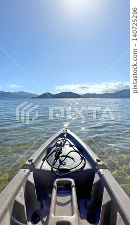 First person view from a kayak on a clear day with sparkling sunlit water and distant mountains First person view from a kayak on a clear day with sparkling sunlit water and distant mountains 140725296